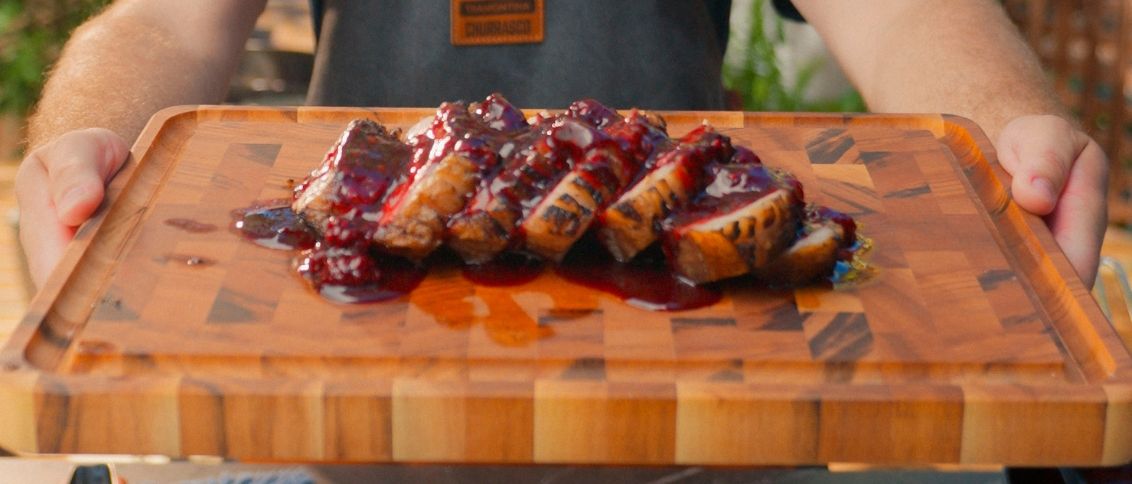 Sliced barbecued pork fillet served with a glossy blackberry glaze