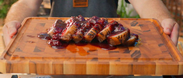 Sliced barbecued pork fillet served with a glossy blackberry glaze